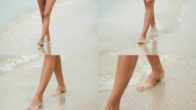 女人的腿在沙滩上行走