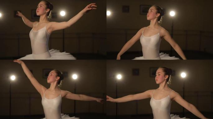 优美的芭蕾舞演员在黑暗中跳舞芭蕾舞元素，背景为光线，缓慢的运动