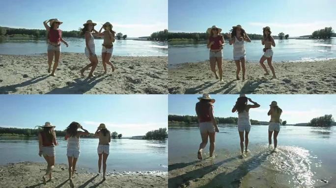 三个女孩在河边海滩玩得开心