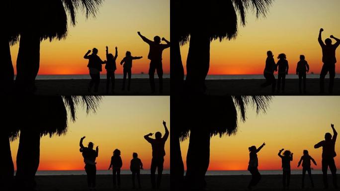 海洋上的日落。父母和孩子的舞蹈剪影