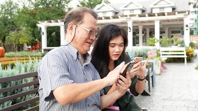 成熟的父亲和女儿一起使用电话