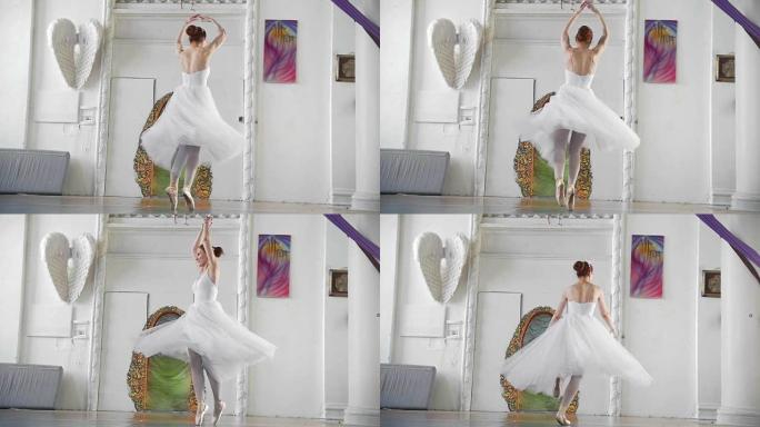 穿着白色短裙的年轻迷人芭蕾舞演员在宽敞的工作室里表演旋转木马