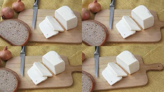 Goat cheese on a wooden cutting board