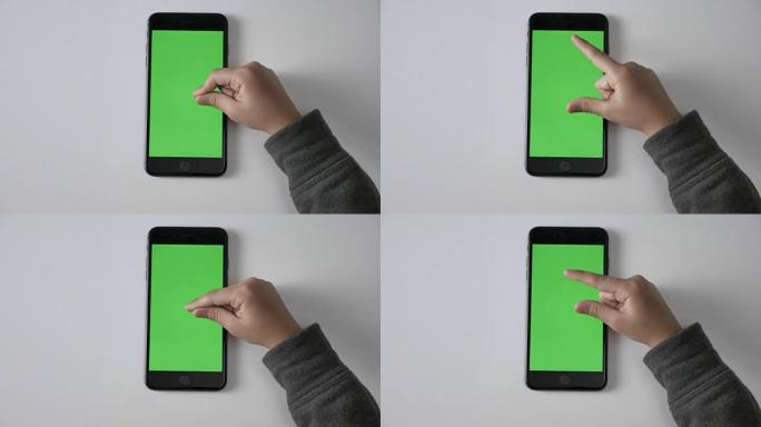儿童的手在智能手机上捏以缩放手势，绿色屏幕，chromakey概念，顶部拍摄60 fps