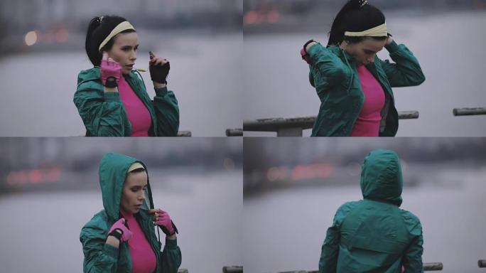 女人慢跑者在寒冷的冬天戴兜帽和无线耳机