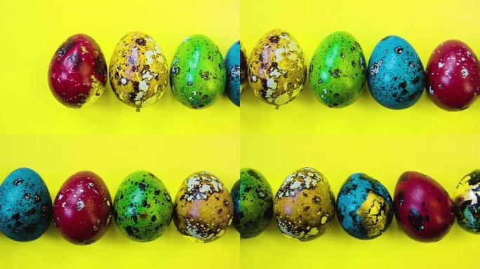 黄色背景上的复活节彩蛋排成一排。