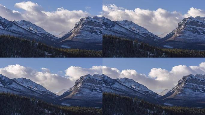 Time lapse of clouds above snowy mountain peaks an