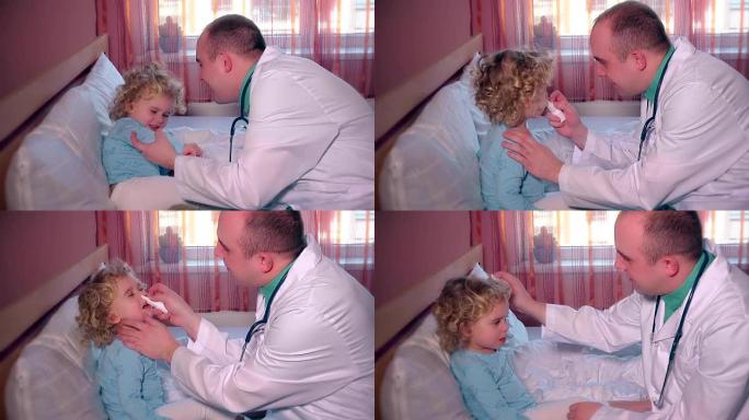 细心的医生使用鼻喷剂治疗鼻塞的小女孩男孩病人