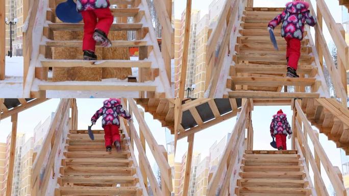 Child is climbing up slide stairs at playground