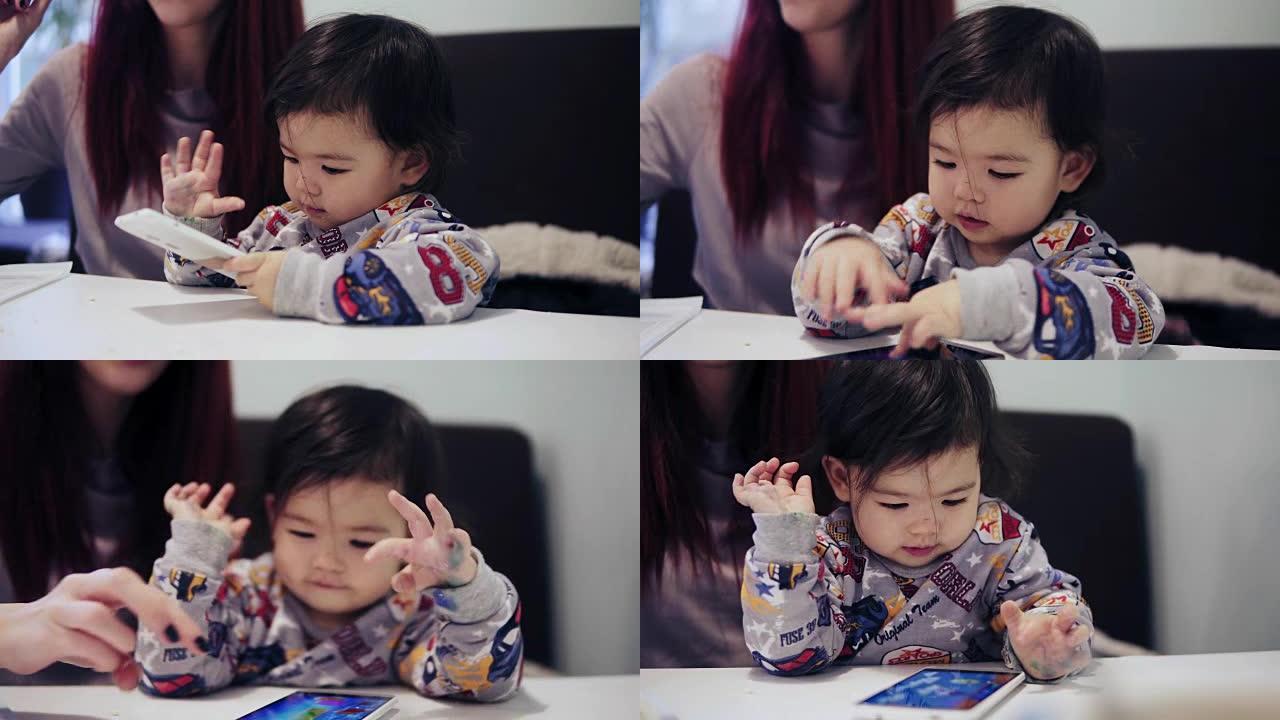An adorable cute asian toddler boy is playing game