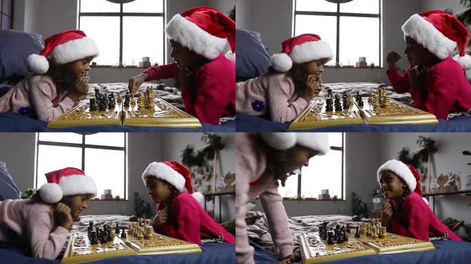 戴着圣诞老人帽子的孩子下棋思考