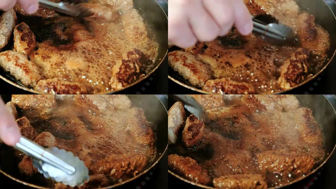 男人的手用金属钳在锅里转过炸肉排。特写视图。