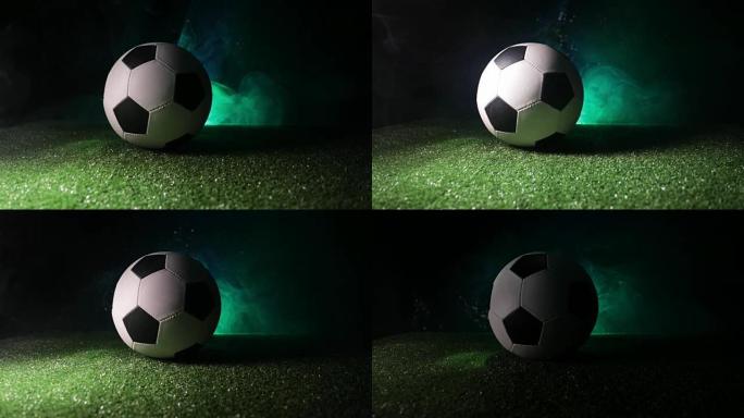滑块镜头。足球场上的传统足球。在绿色的草地上近距离观察足球 (足球)，背景为深色的雾气。选择性聚焦