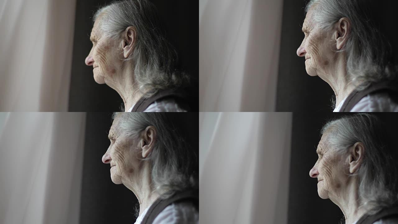 灰色头发的悲伤老妇人的特写脸。