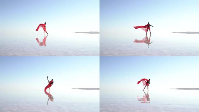 美丽的芭蕾舞演员在湖上跳舞，穿着红色薄纱