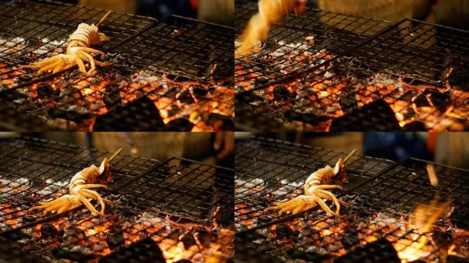 乌贼在夜市的烧烤炉排上煮熟，泰国街头小吃。泰国