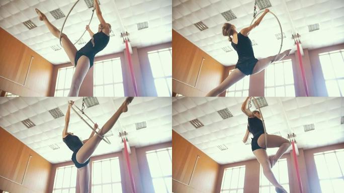 年轻的芭蕾舞演员用空中箍练习元素