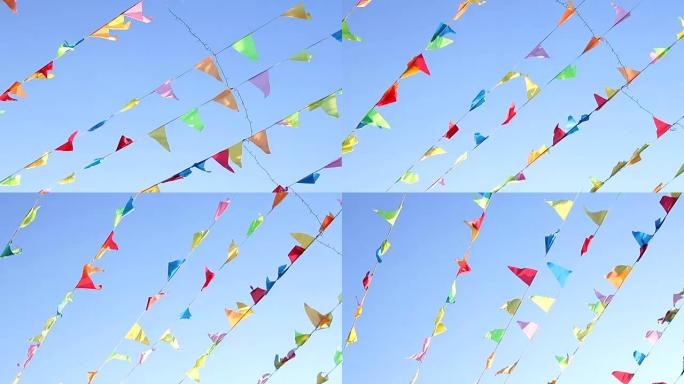 三角旗在风中飞翔，有着可爱的实心蓝光天空背景。