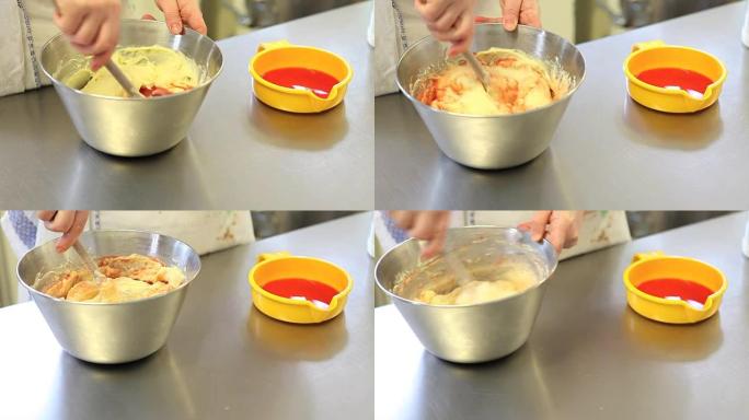 糕点厨师手在碗里搅拌奶油冻，橙色调味料，糖果操作台上的特写镜头
