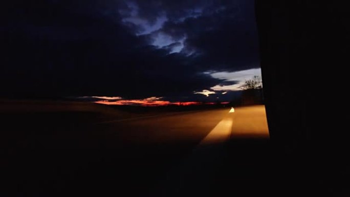 黄昏时分在道路上行驶，日落