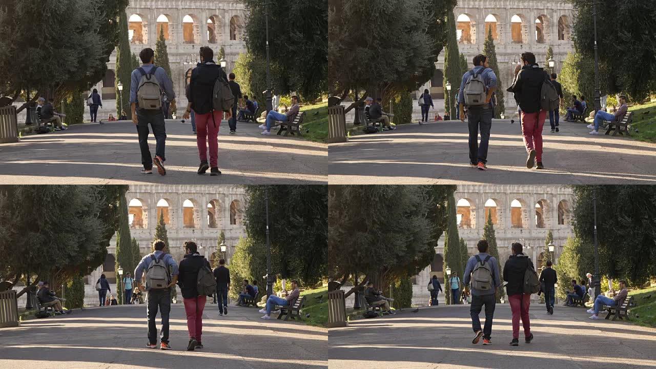 日落时分，两个年轻的朋友游客带着背包走向罗马科勒奥皮奥的罗马斗兽场