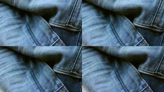 蓝色牛仔牛仔裤的特写细节，纹理背景