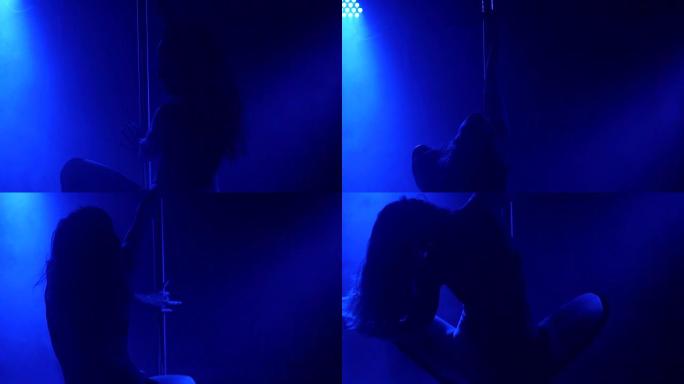 女孩在黑暗中表演色情舞蹈的剪影