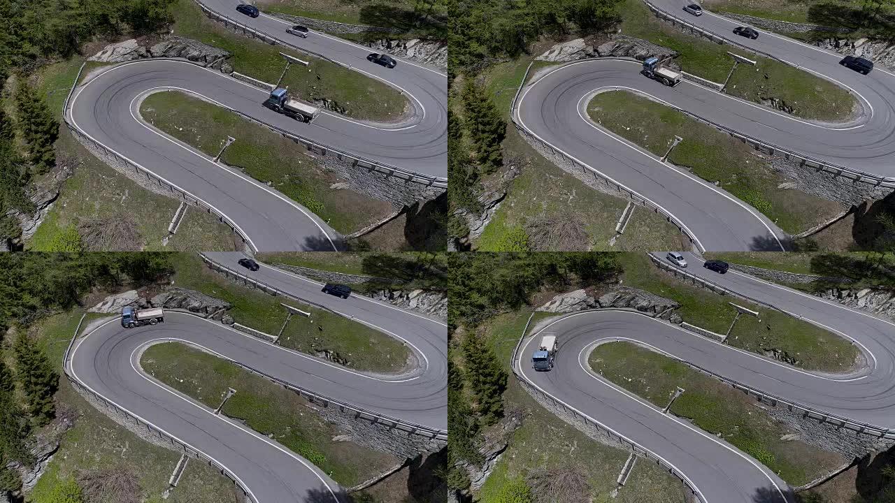 山蛇形公路的鸟瞰图，卡车和汽车在之字形上行驶，在欧洲瑞士4K