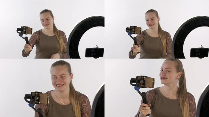 带手机摄像头稳定器的女孩为vlog制作视频