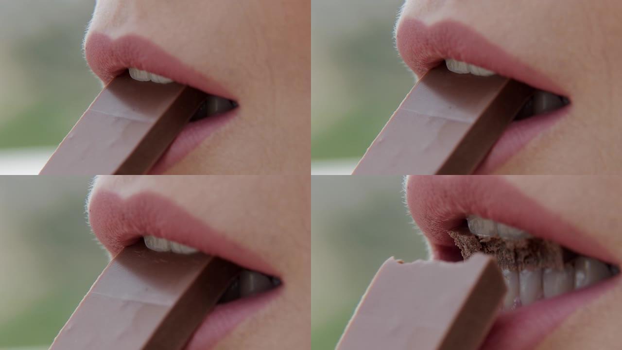 特写粉红色女性嘴唇咬巧克力棒