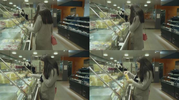 亚洲女商人在超市购买食物。