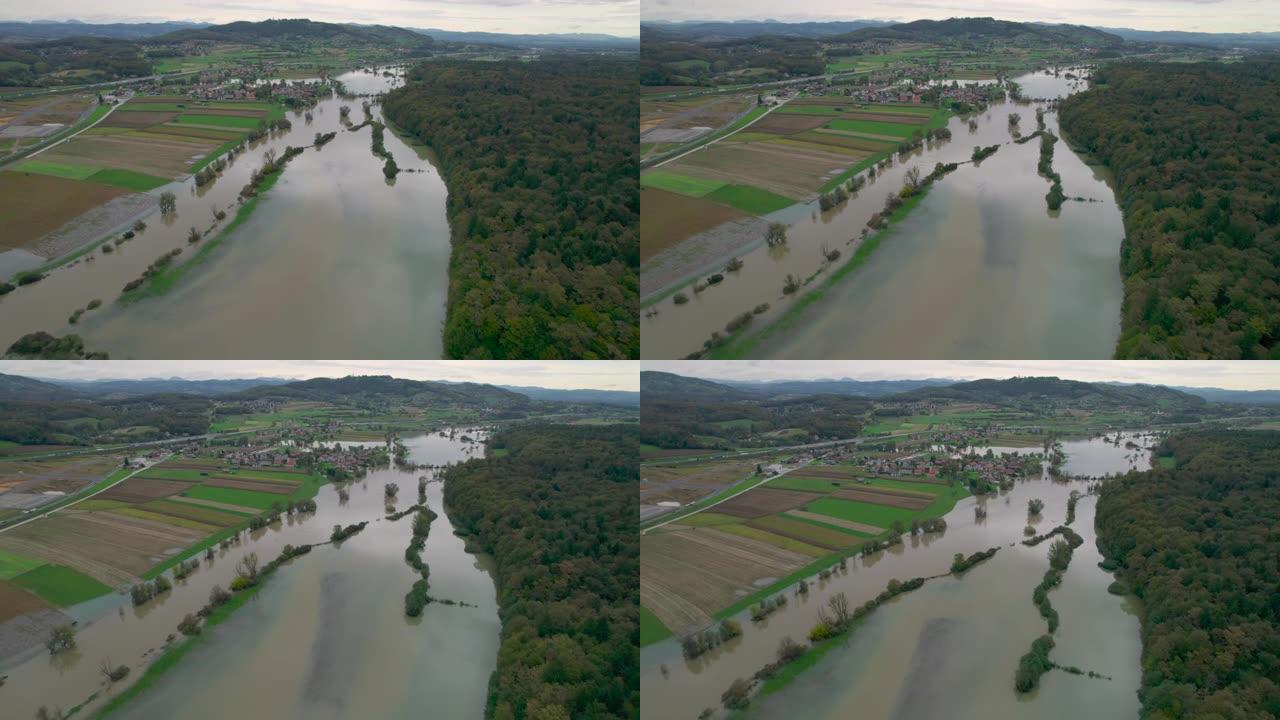 空中: 浑浊的河水泛滥到乡村景观上