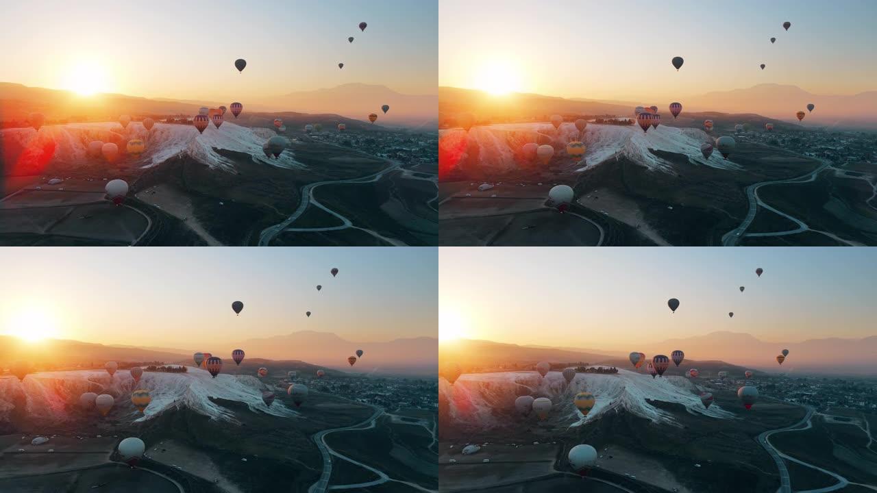 热气球飞越棉花堡山谷，对抗山脉和喜怒无常的天空。空中无人机视频