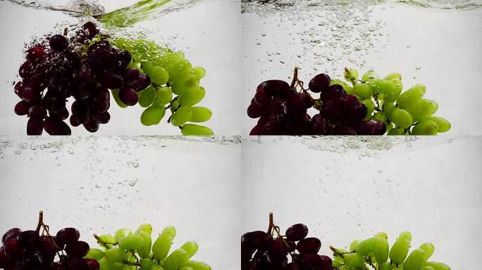 红色和绿色葡萄的慢动作视频。一束葡萄被浸泡在带有气泡的水中。