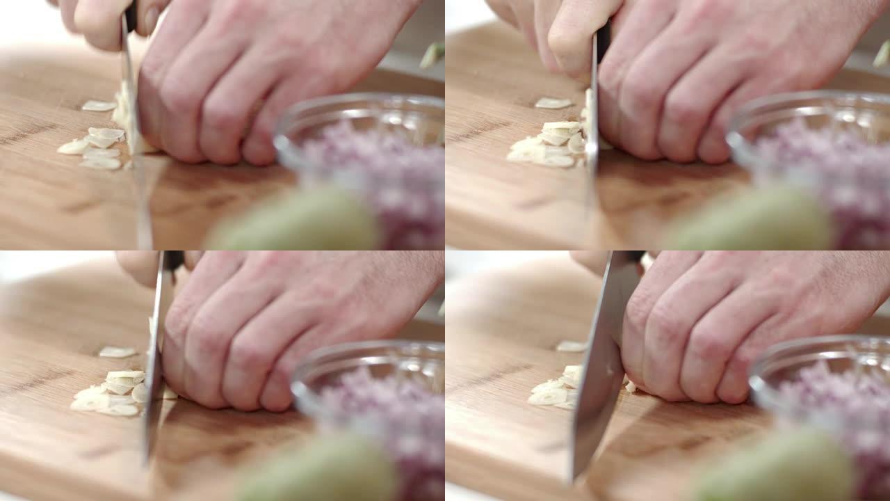 厨师用菜刀切成蒜瓣