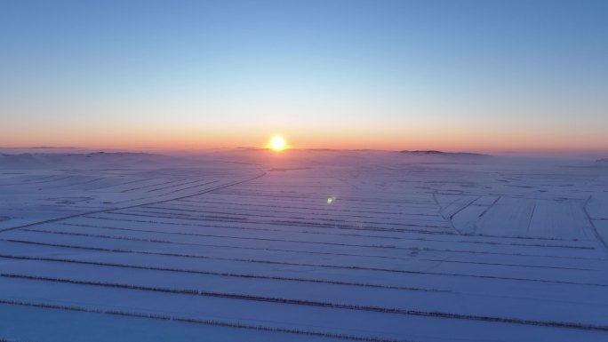 航拍4K东北垦区田野雪景日落