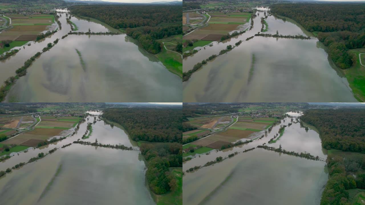 空中: 上升的泥泞河流泛滥成河，淹没了乡村