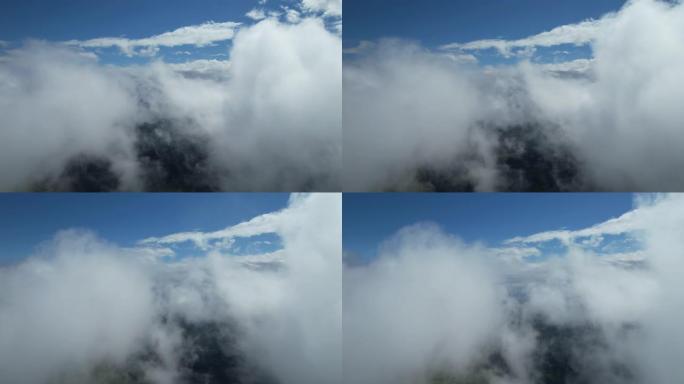 从驾驶舱的景色，云层之间的飞行，蓝天，巨大的软云。