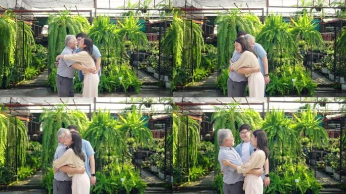 4k亚洲夫妇和年迈的父亲在户外工厂见面时互相拥抱。