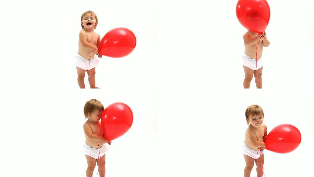 婴儿在白色背景上玩红色气球
