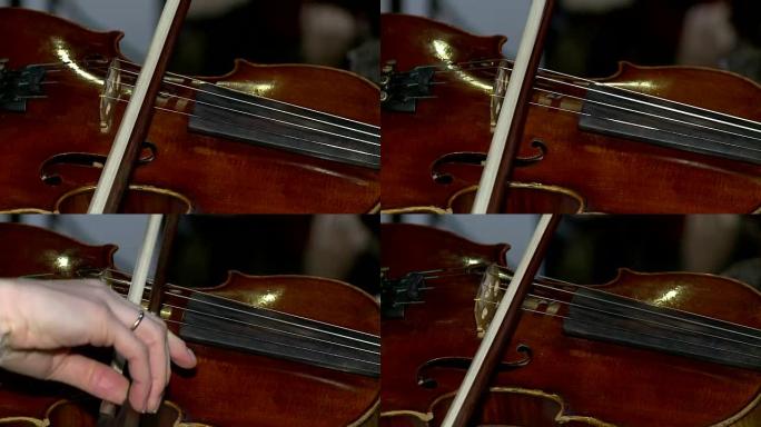 小提琴现场音乐会，女性手演奏小提琴的特写镜头