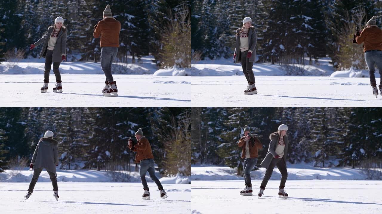 SLO MO男子在阳光下拍摄女子在冰冻的湖面上滑冰的视频