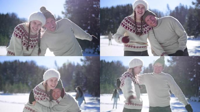 一对夫妇在阳光下冰冻的湖面上滑冰时微笑的SLO MO肖像