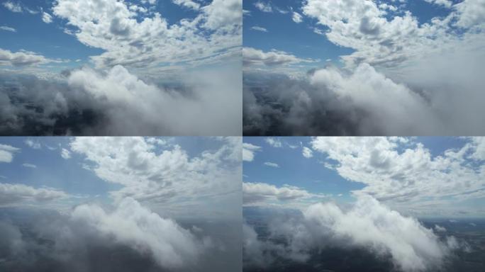 从驾驶舱的景色，云层之间的飞行，蓝天，巨大的软云。
