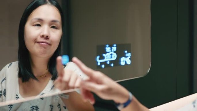 亚洲女性在房子里调节和控制灯光的特写镜头。家庭自动化和智能家居技术。