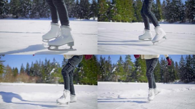 一个女孩的SLO MO TS腿在阳光下的冰冻湖上滑冰