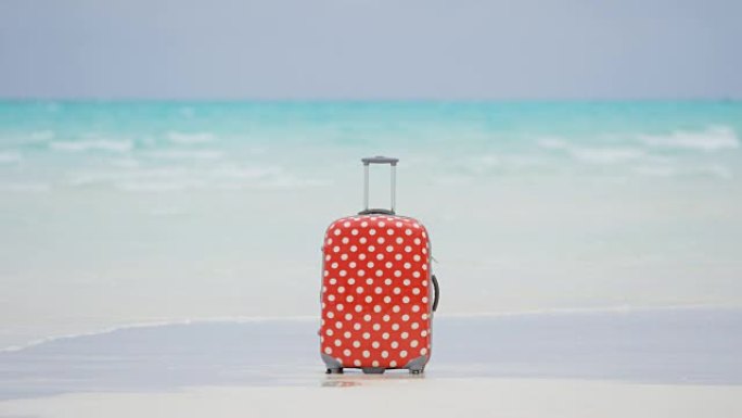 白色沙滩上的彩色旅行箱
