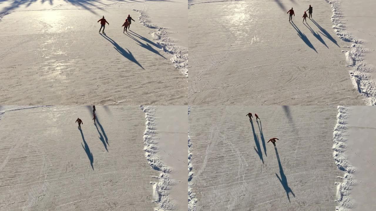 三口之家上方的天线在冰冻的湖上滑冰