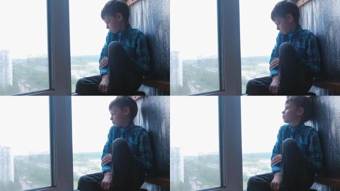 男孩在雨中看着窗外，很悲伤。