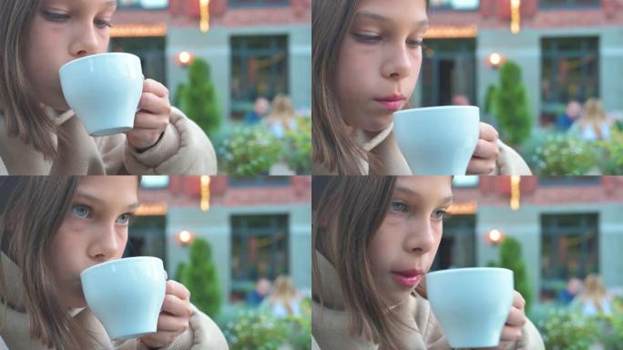 那个女孩在餐馆用勺子喝汤。4k视频片段